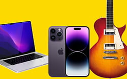 Guitar, laptop and phone on yellow background